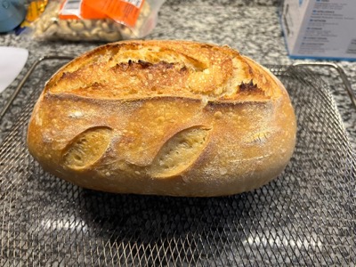 Baked sourdough boule with a scored crust
