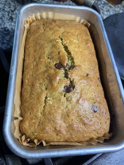 Baked loaf of eggless zucchini bread in the pan