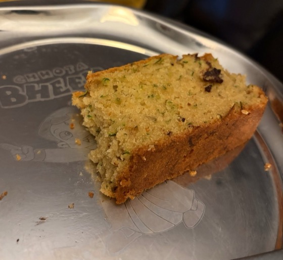 Slice of zucchini bread showing the moist green-flecked crumb