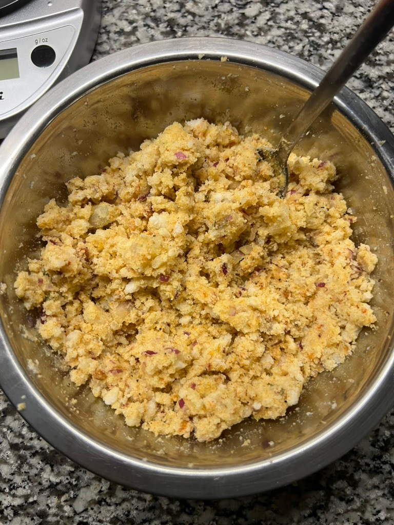 Choor choor aloo filling, crumbly and dry, in a mixing bowl